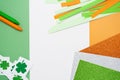 Irish flag made from color paper with cut out shamrock clover crayons and glitter paper Royalty Free Stock Photo