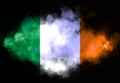 Irish flag performed from color smoke on the black background. Abstract symbol