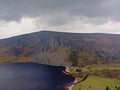 Dark clouds over Guiness lake in wicklow mountains Royalty Free Stock Photo