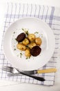 Irish meal with black pudding and baby potatoes and parsley