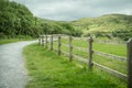 Irish outdoor green landscape with a wooden fence