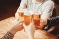 Irish pub. Guys clinking with beer mugs cheers Royalty Free Stock Photo