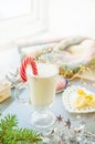 Irish traditional winter cream cocktail eggnog in a glass mug with milk, rum and cinnamon, banana covered with whipped cream, Royalty Free Stock Photo