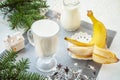 Irish traditional winter cream cocktail eggnog in a glass mug with milk, rum and cinnamon, banana covered with whipped cream, Royalty Free Stock Photo