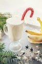 Irish traditional winter cream cocktail eggnog in a glass mug with milk, rum and cinnamon, banana covered with whipped cream, Royalty Free Stock Photo