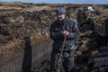 An Irish turf cutter, cutting sods of turf with a sleÃÂ¡n.