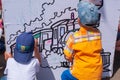 Irkutsk city, Russia - June 8, 2019. On a sunny summer day, boys draw with felt-tip pens on the street.