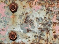 Iron with aged paint of different colors and rust and two rusty nuts