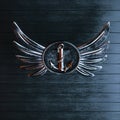 Iron anchor on a winged emblem on a background of black painted