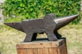 Iron anvil on wooden table Royalty Free Stock Photo