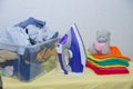 Iron and baby clothes. Colored clothes on an ironing board. Bright t-shirts. Ironed and non-ironed colored children`s underwear o Royalty Free Stock Photo