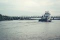 Iron barge and pusher tug boat on River. Large cargo barge transporting iron to main harbor for exporting along river. Royalty Free Stock Photo