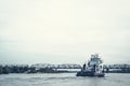 Iron barge and pusher tug boat on River. Large cargo barge transporting iron to main harbor for exporting along river.