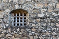 iron bars in medieval castle window and stone old wall of a medieval An Felipe castle construction in Guatemala. Background Royalty Free Stock Photo