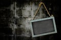 Iron blackboard hanging on old grunge wall texture with vignette Royalty Free Stock Photo