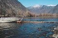 Iron boat is tied with rope to wooden pier. Crossing spring river. Evacuation of people in high water Royalty Free Stock Photo