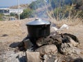 Iron bowler on the fire in a Refugee camp on a Greek island,Greece Royalty Free Stock Photo