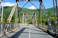 Iron bridge over the river. Siberia. Royalty Free Stock Photo