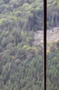 Iron cable from the transportation system of the funicular on the background of a green mountain fores