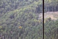 Iron cable from the transportation system of the funicular on the background of a green mountain fores