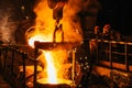 Iron casting. Molten metal pouring from blast furnace into ladle. Steel production in foundry workshop. Metallurgical Royalty Free Stock Photo