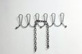 Iron chain on a clothes hanger on a white wall with copy space Royalty Free Stock Photo