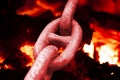 Iron chain links heated by a furnace fire
