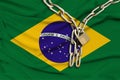 Iron chain and lock on Brazil national silk flag with beautiful folds, the concept of a ban on tourism, political repression,