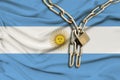 Iron chain and lock on the silk national flag of Argentina with beautiful folds, the concept of a ban on tourism, political