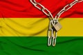 Iron chain and lock on the silk national flag of bolivia with beautiful folds, the concept of a ban on tourism, political