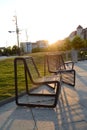 Iron chairs at main railway station building at sunset.