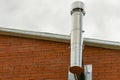 Iron chimney from the fireplace to heat a house with copy space on the roof background