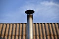 Iron chimney on the roof of the house Royalty Free Stock Photo
