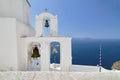 Iron church bells on a chapel roof on the romantic volcanic island of Santorini Greece popular European holiday destination Royalty Free Stock Photo