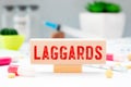 word Laggards on wooden block, medical concept