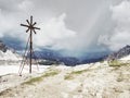 Iron cross at path around mountain Tre Cime in South Tyrol Royalty Free Stock Photo