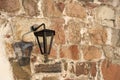 Iron decorative lantern on an old wall of granite stone. Royalty Free Stock Photo