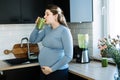 Iron deficiency, anemia, iron boosting smoothie recipes for pregnant woman. Pregnant woman preparing green vitamin