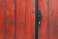 Iron door handle on old wooden door close up outdoor shot Royalty Free Stock Photo