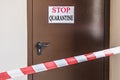 An iron door in the hospital with a warning sign STOP.KARANTIN behind the signal forbidden tape. Coronavirus Pandemic, Covid-19