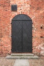 Iron door in a red brick wall. Gothic castle of Pomeranian dukes Royalty Free Stock Photo