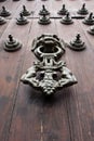 Iron Doorknocker on Wooden Door