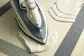 Iron is an electrical appliance for homework. Ironing of textile maske.