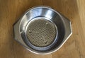 Iron empty colander on wooden background