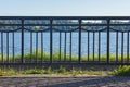 Iron fence in front of the river on a sunny day