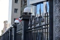 Iron fence with pins and lanterns in the city Royalty Free Stock Photo