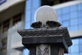 Iron fence with pins and lanterns in the city Royalty Free Stock Photo