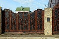 Iron forged large gate on a fence in the street Royalty Free Stock Photo