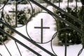 Iron gate with catholic cross to cemetery at winter Royalty Free Stock Photo