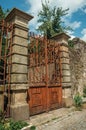 Iron gate covered by rust in front of old mansion Royalty Free Stock Photo